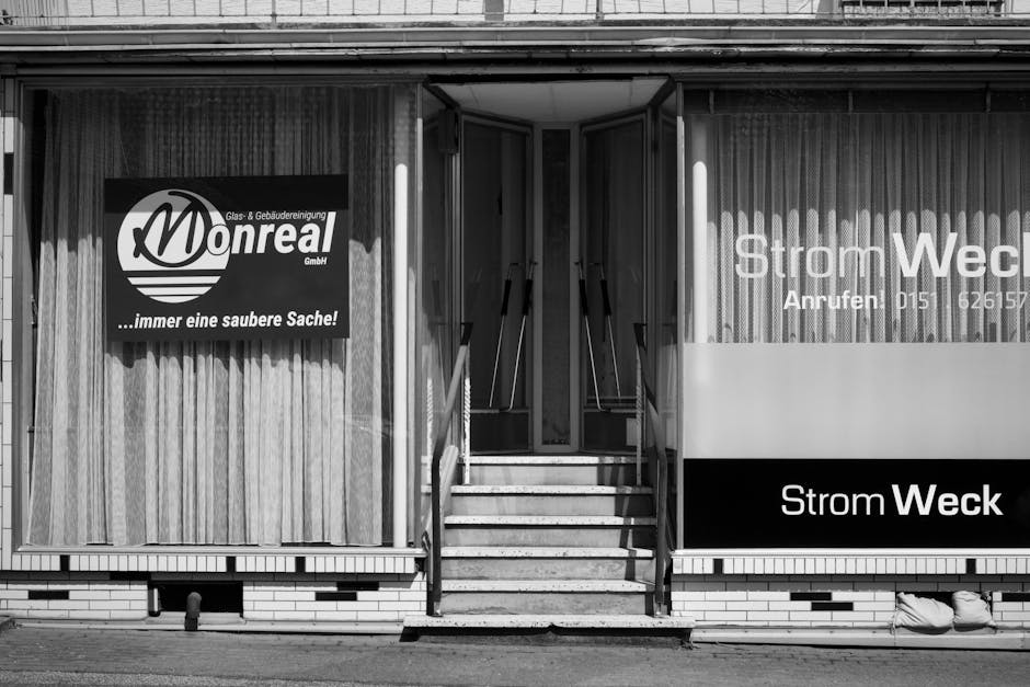 treppenhausreinigung münchen - Monreal GmbH building facade with signage in a monochrome style.