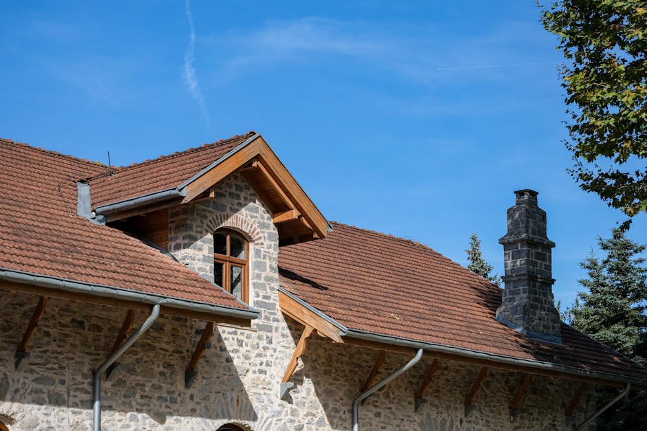 reinigung & wartung - Rustic stone house with red roof and chimney, under a clear blue sky in İstanbul, Türkiye.